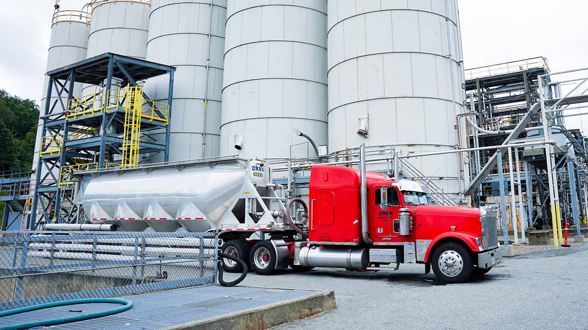 Semi truck and tanker pulls away from manufacturing facility